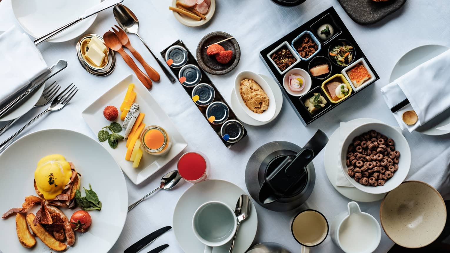 A wide array of Japanese and western-style breakfast foods, including eggs Benedict, assorted cheeses and sides