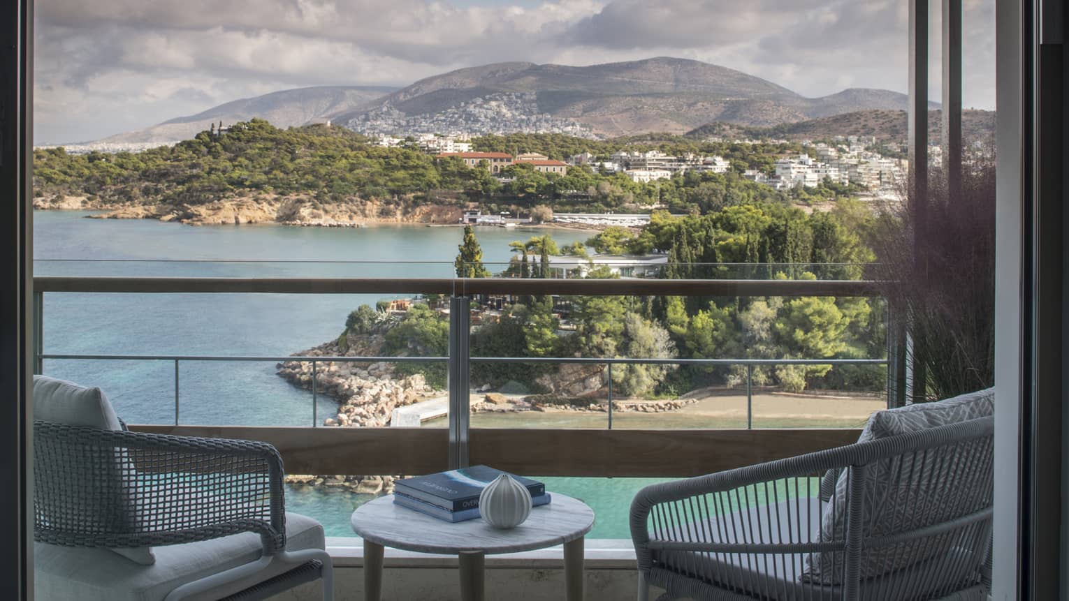Four Seasons Astir Palace Hotel Athens balcony chairs, table with books, overlooking sea, trees, mountains