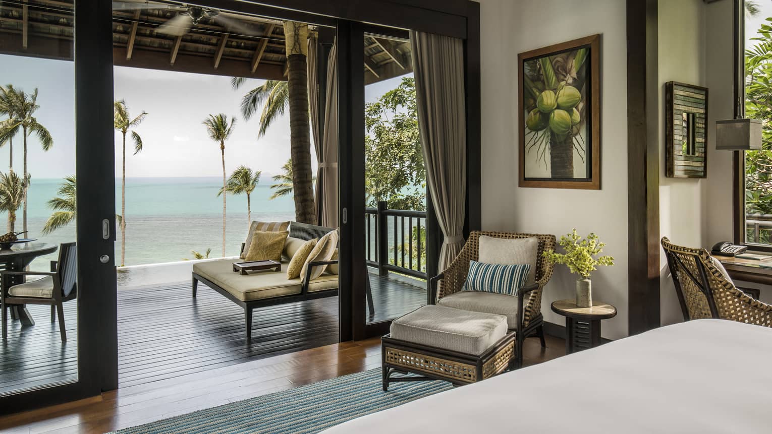 Villa bedroom with queen bed, rattan furniture and private beach access 