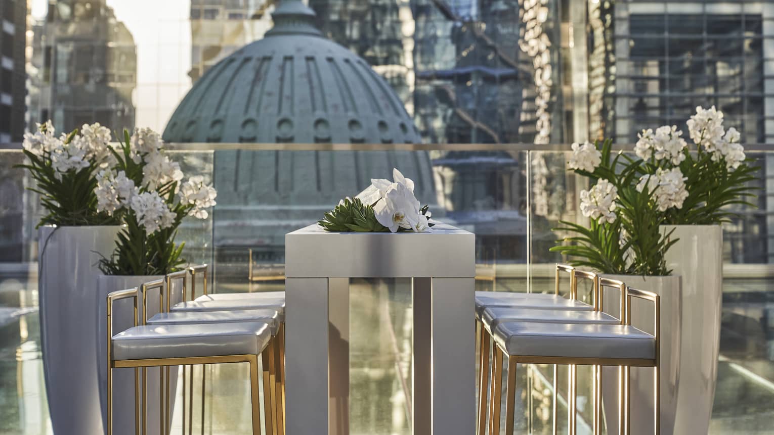 The outdoor Ballroom terrace is decorated with a silver table lined with white flowers and overlooks Philadelphia