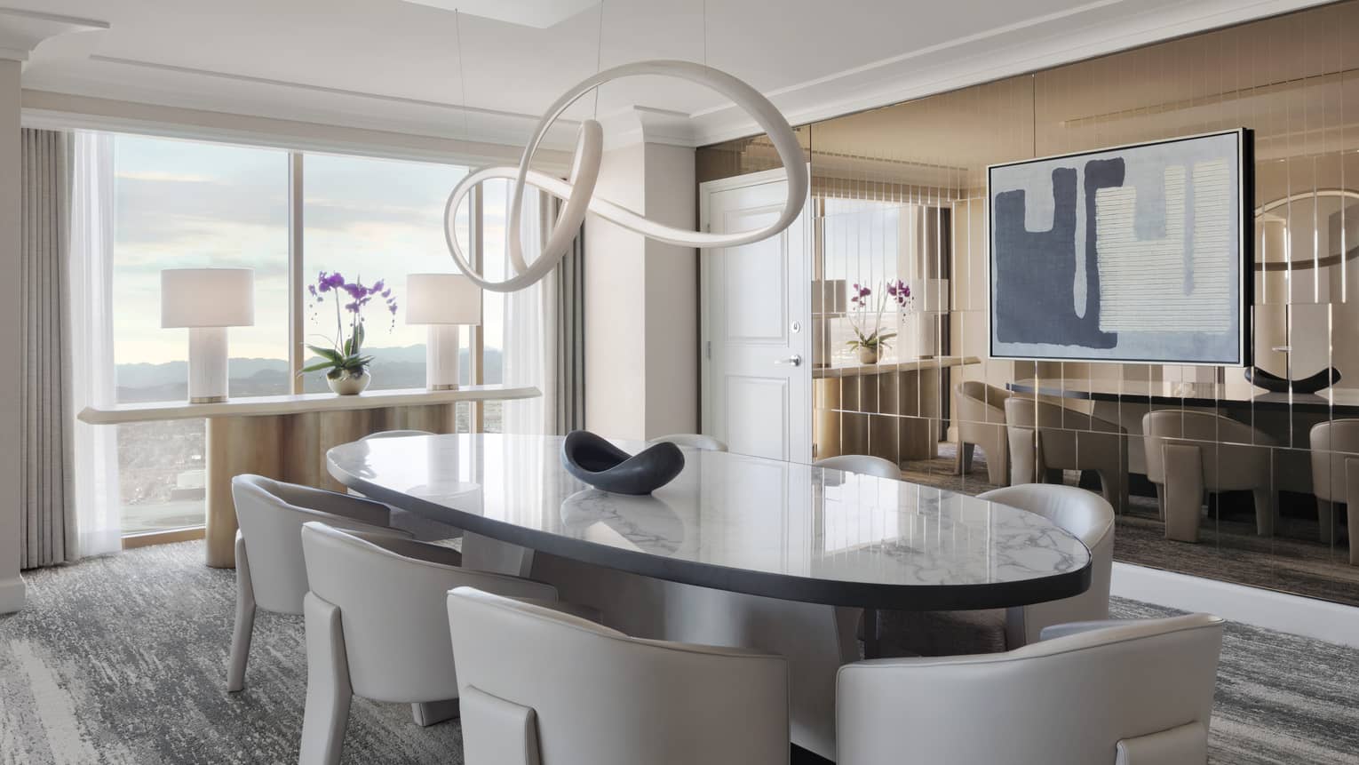 Contemporary dining room with large oval table and eight leather chairs, Presidential Suite at Four Seasons Hotel Las Vegas