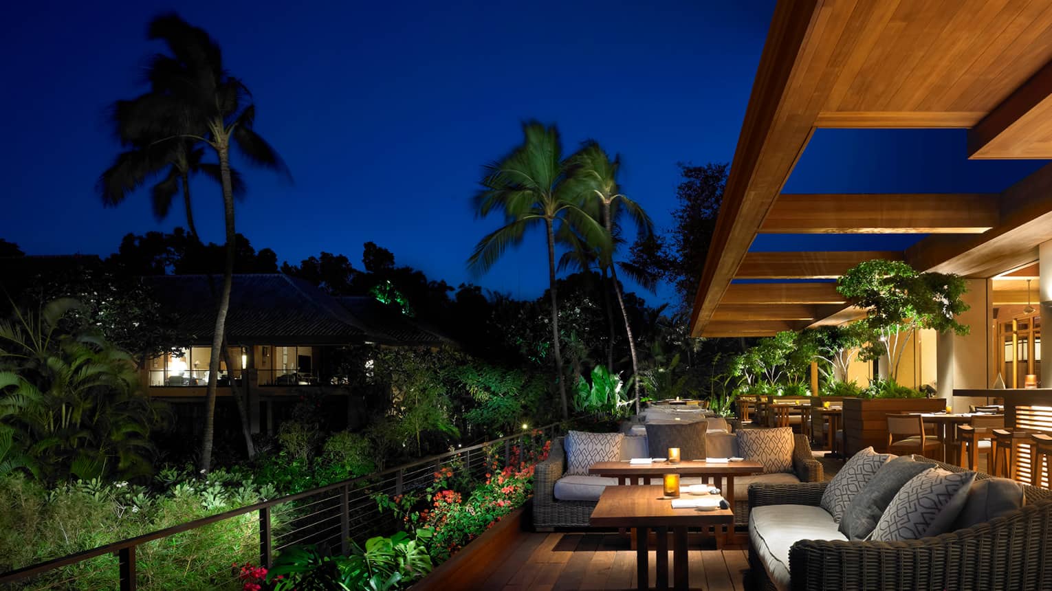 NOBU Lanai  restaurant patio lounge tables, bar with lights at night