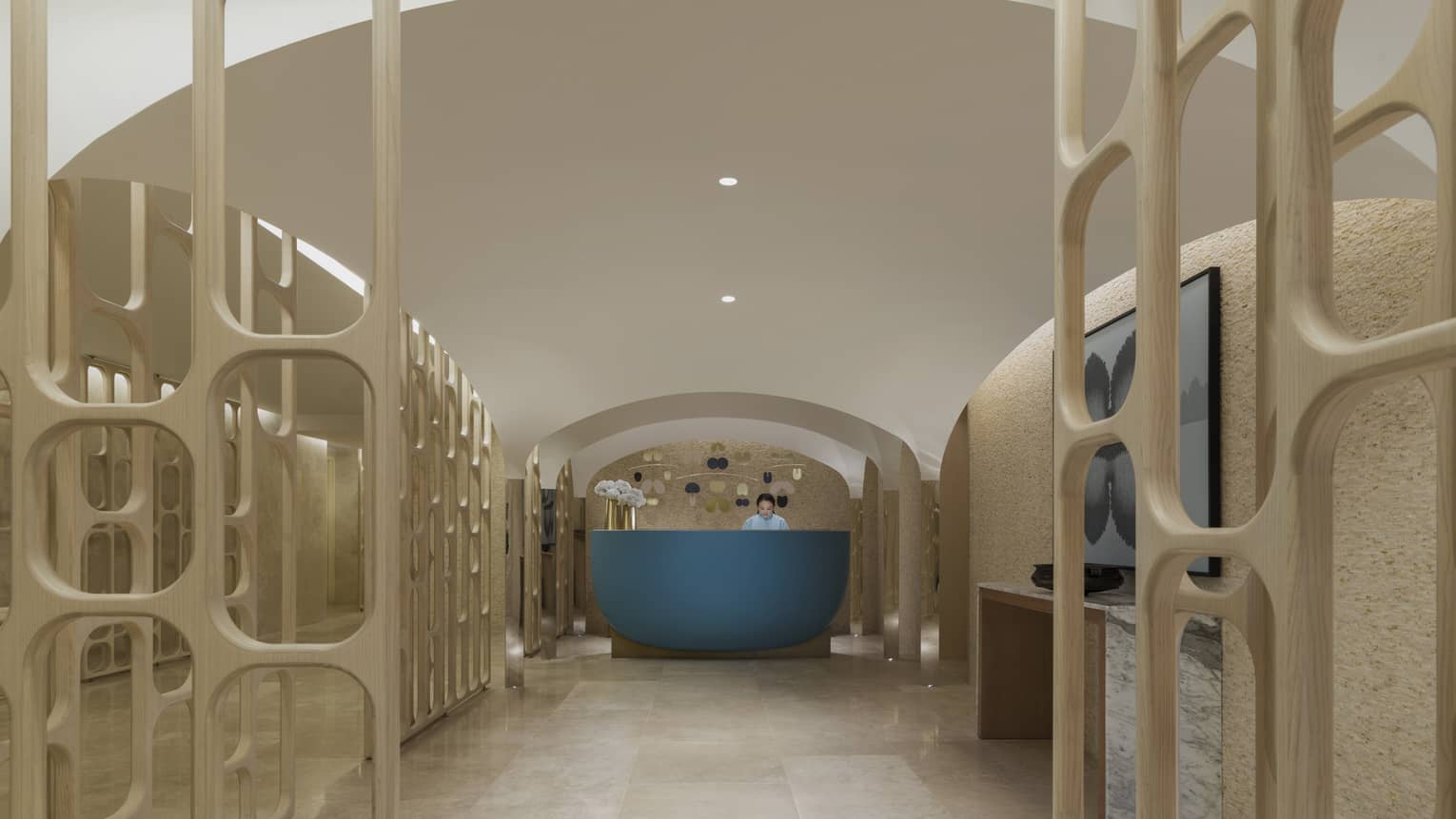 The spa entrance is marked by a blue desk sits on a marble floor