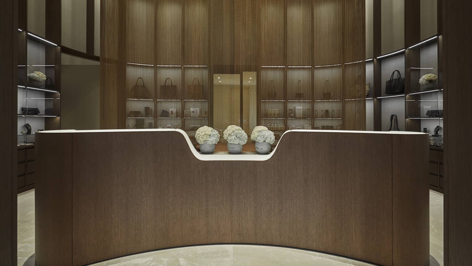 Entrance of the Spa boutique with three vases of white flowers.