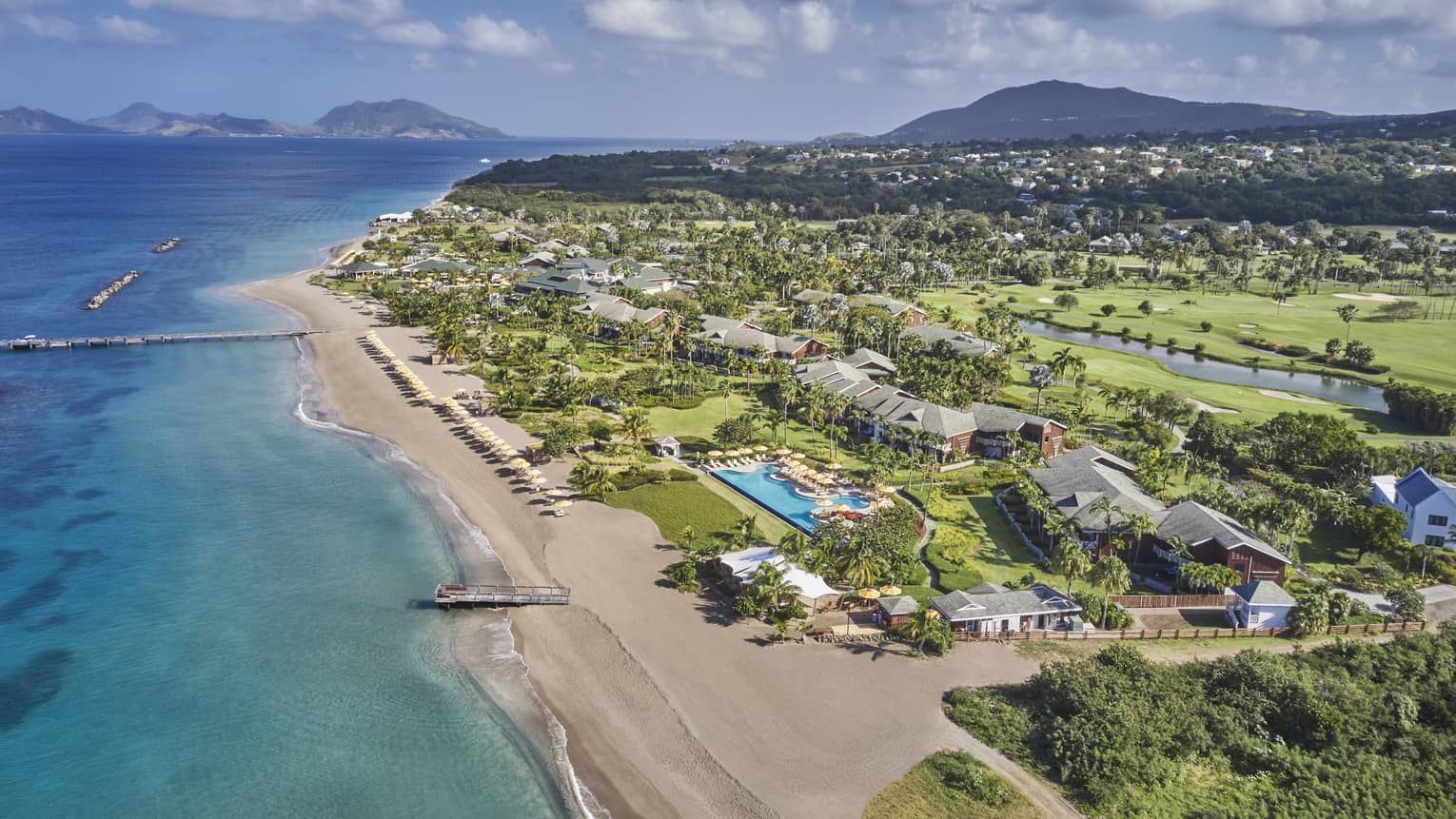 Aerial view of a resort property on a beach shore.