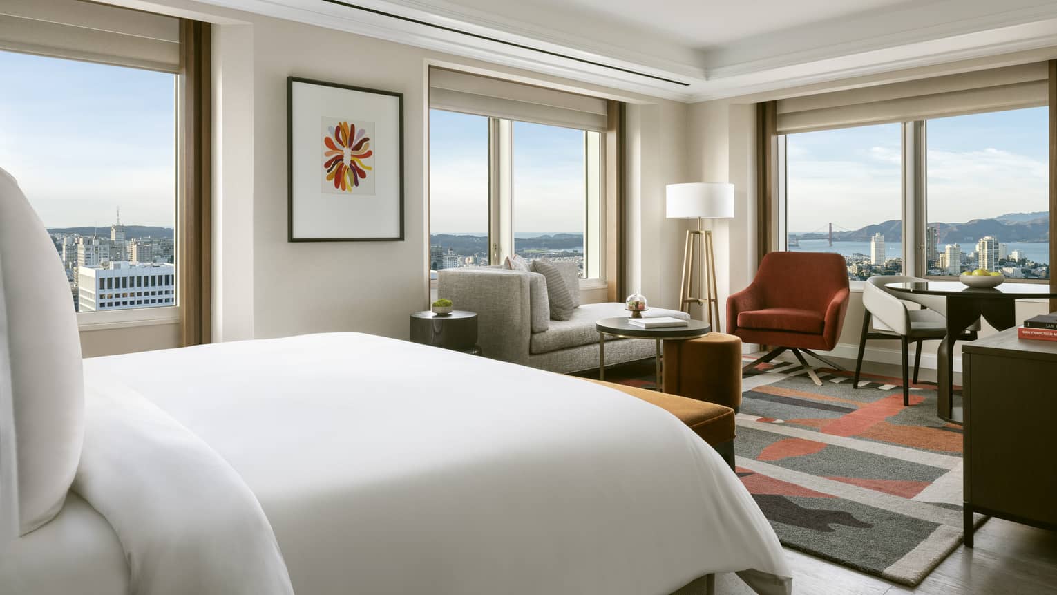 Modern hotel room with queen bed and corner views of San Francisco and bay