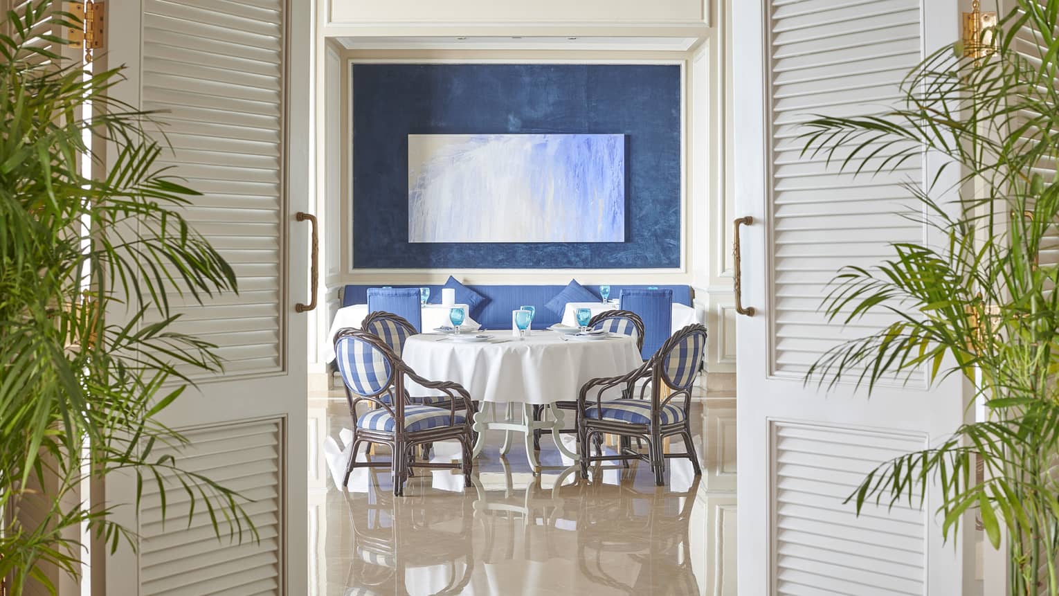 Kala Restaurant dining area with blue accents and palm plants