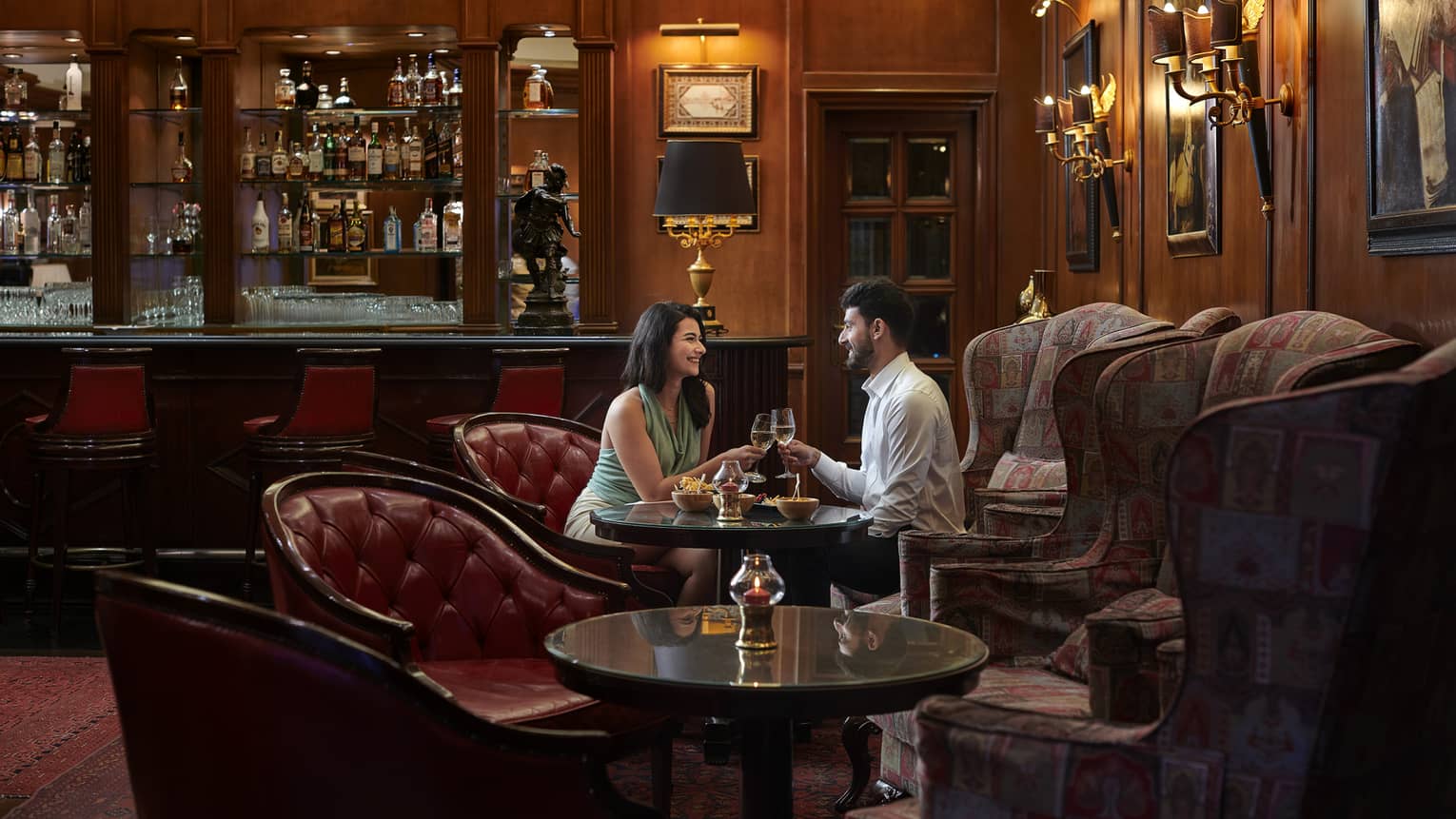 Couple enjoys a glass of wine in the sitting area of Le Bar