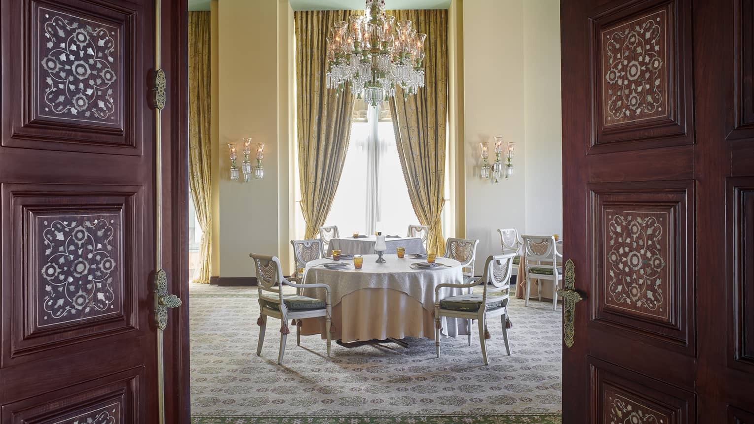 Byblos Restaurant dining area with gold curtains and chandelier