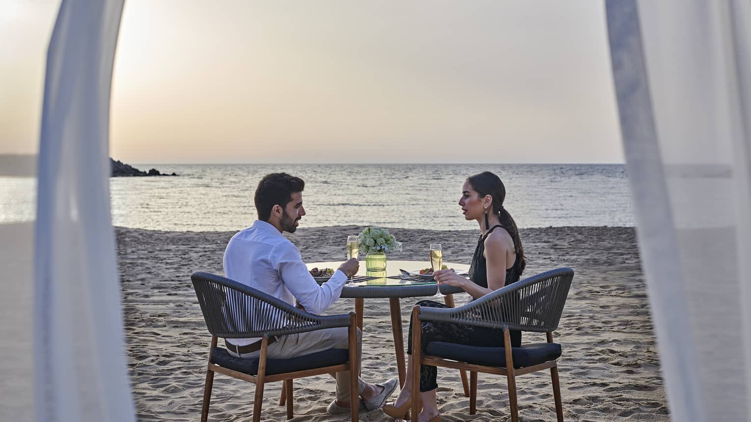 A couple has a romantic dinner for two on the beach at four seasons alexandria