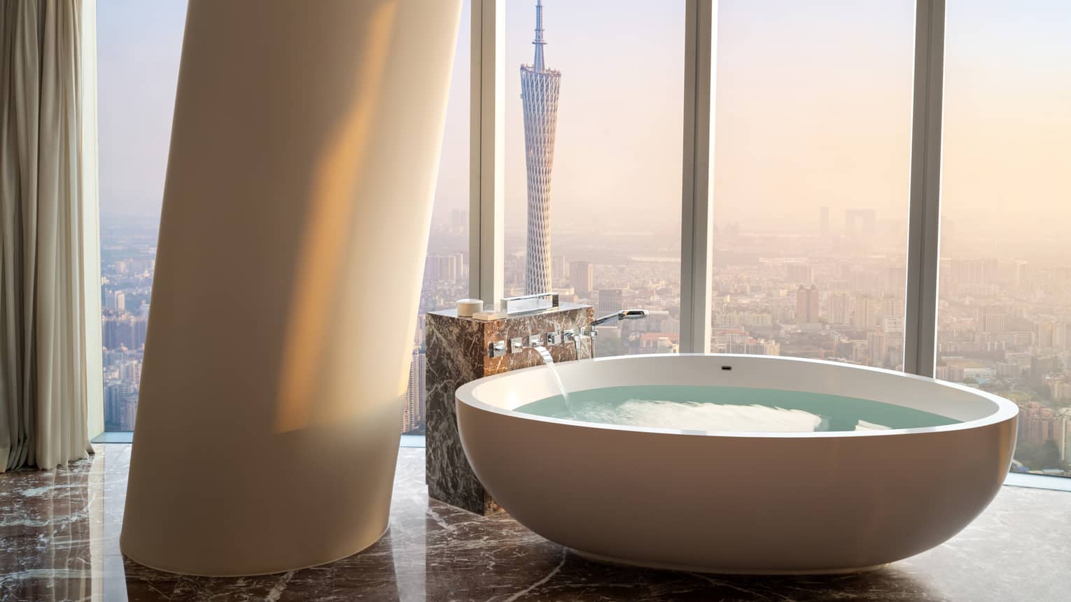 Deluxe Twin Canton Tower View Suite soaking tub with floor-to-ceiling windows