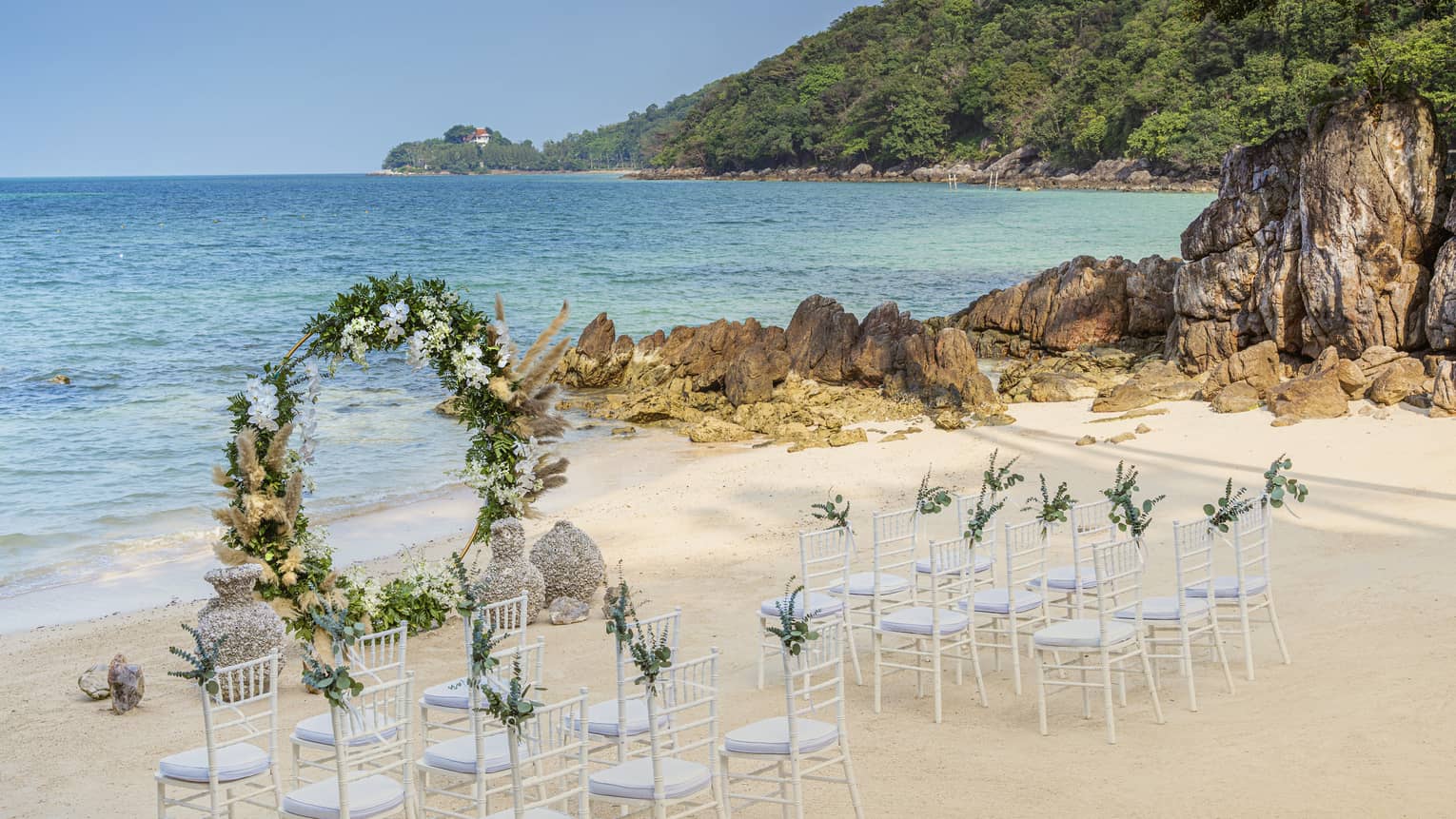 Wedding setup on beach with round flower arch