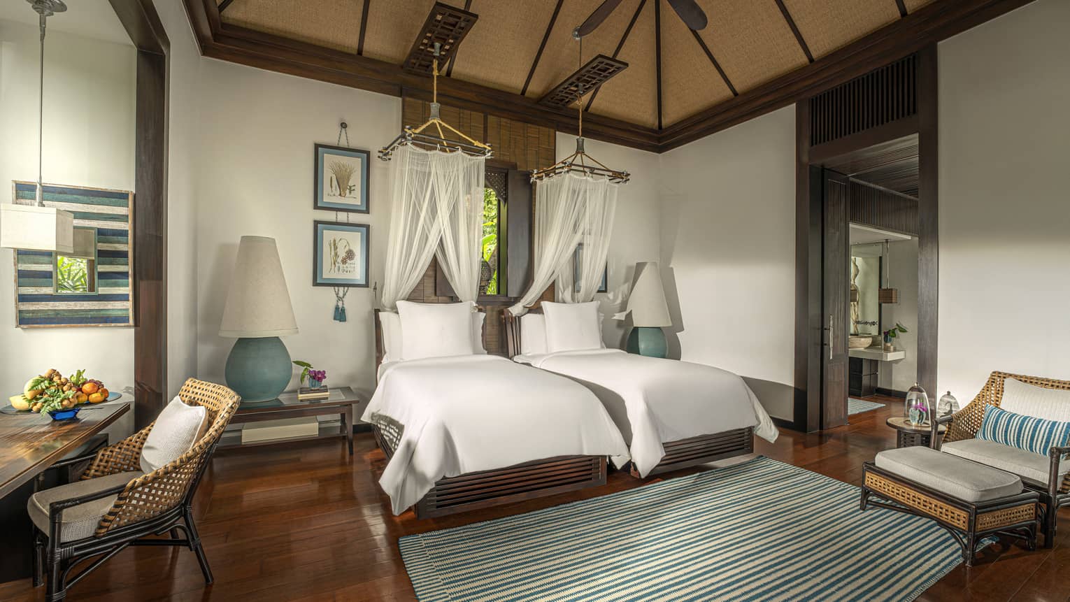 Bedroom with two twin beds, each with a net canopy