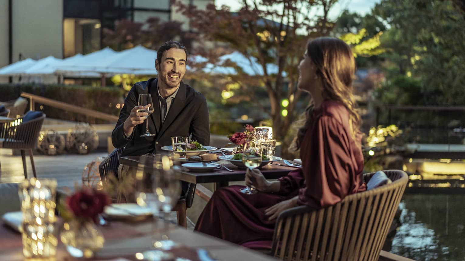 Couple enjoys a romantic meal at dusk on Brasserie?s outdoor terrace with views of Shakusui-en pond garden