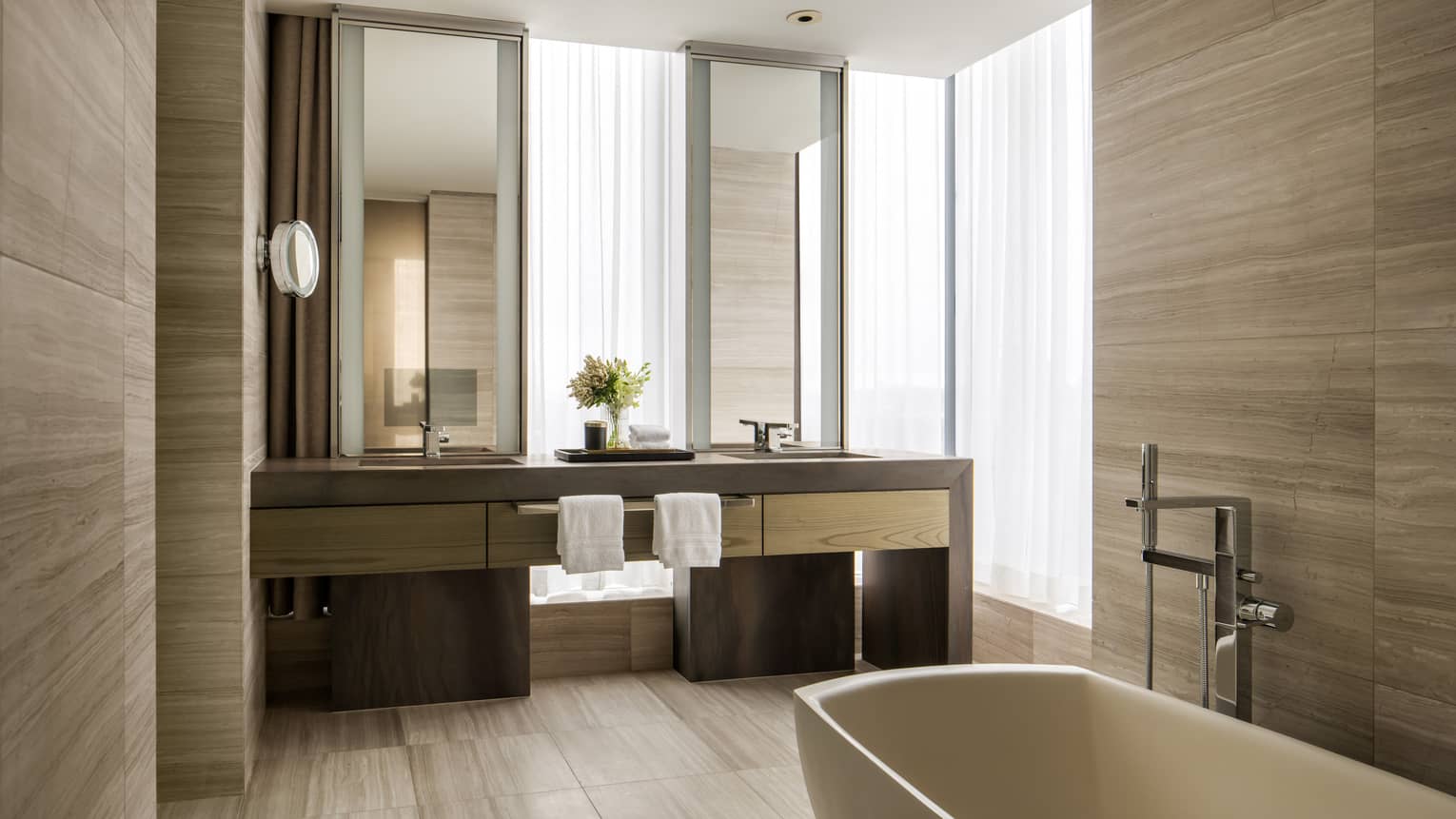 Hotel suite bathroom with double vanity and standalone tub at Four Seasons Hotel Toronto