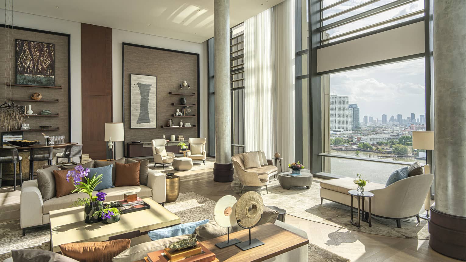 Lavish suite living area with window overlooking Bangkok river