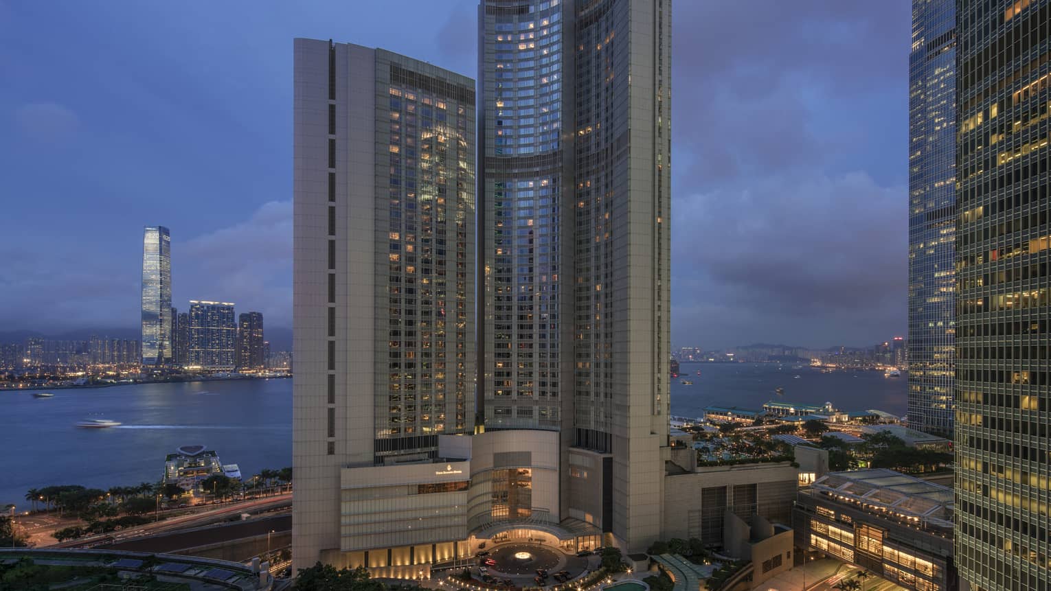 Four Seasons Hotel Hong Kong high rise exterior at dusk