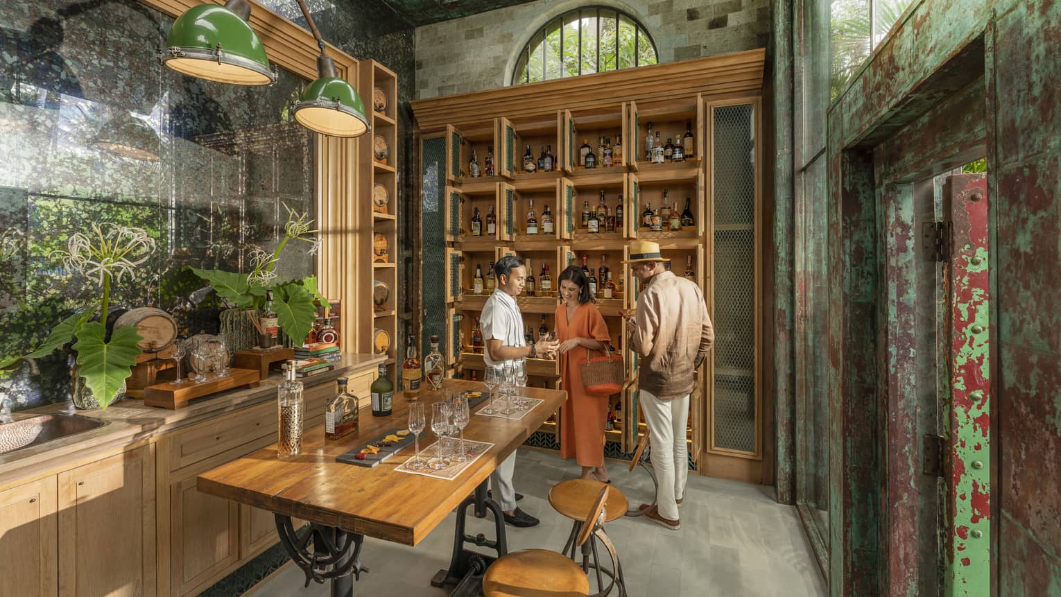 Male staff member offers samples to couple at Rum Vault