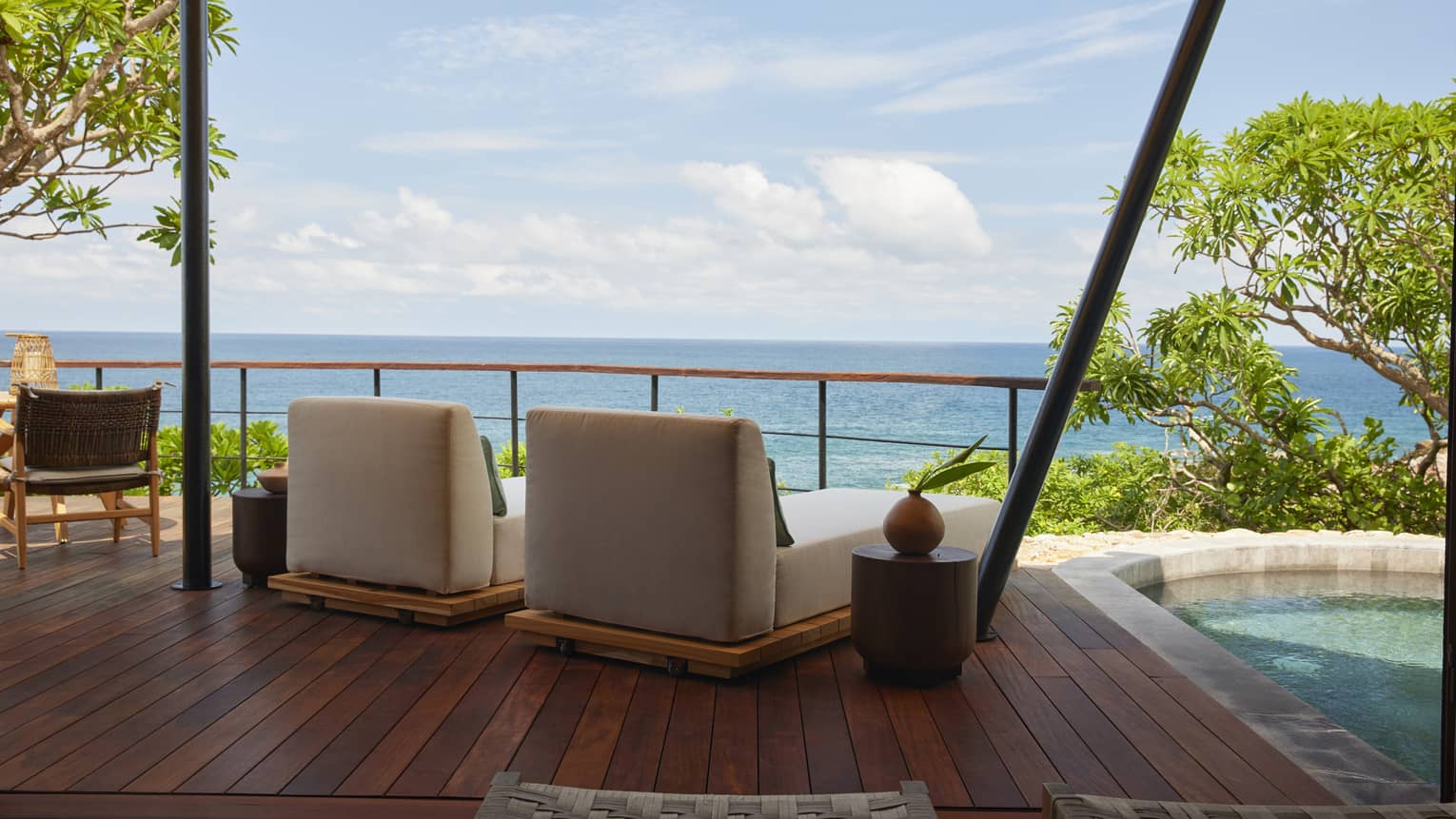 Shaded deck of luxury tent overlooking the ocean, with private plunge pool and two lounge chairs