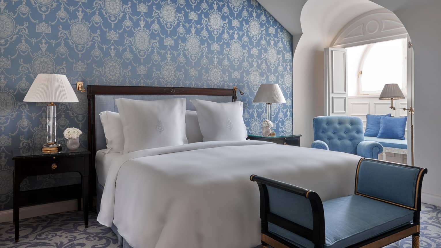Hotel bedroom with blue wallpaper