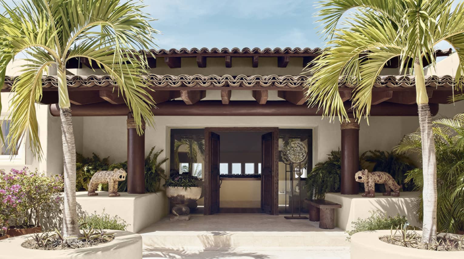 Entrance to private villa with palm trees