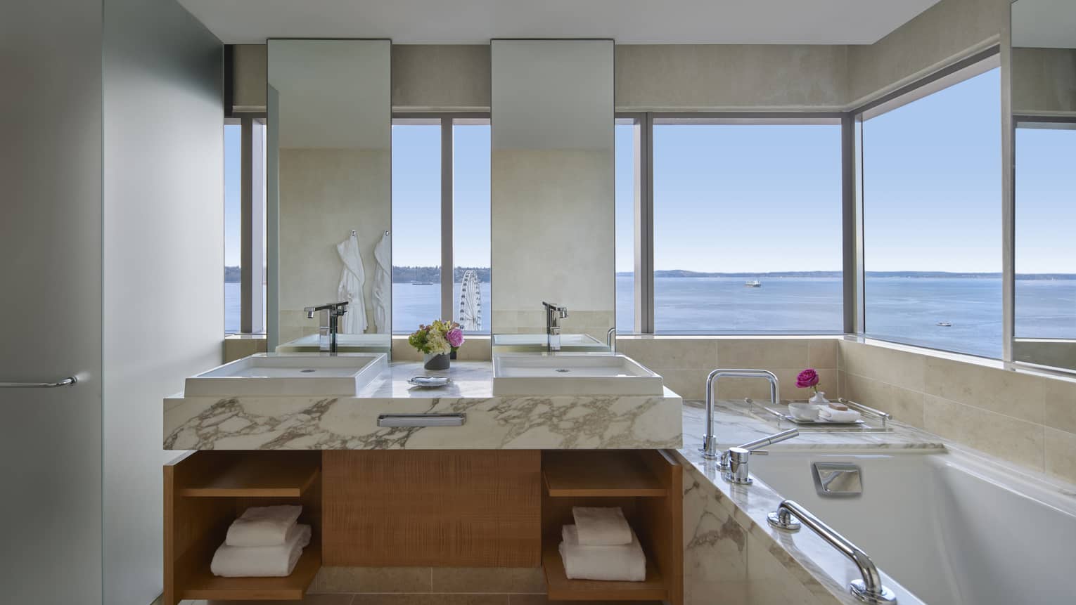Bathroom with marble double vanity, sunken tub and wrap-around wall of windows