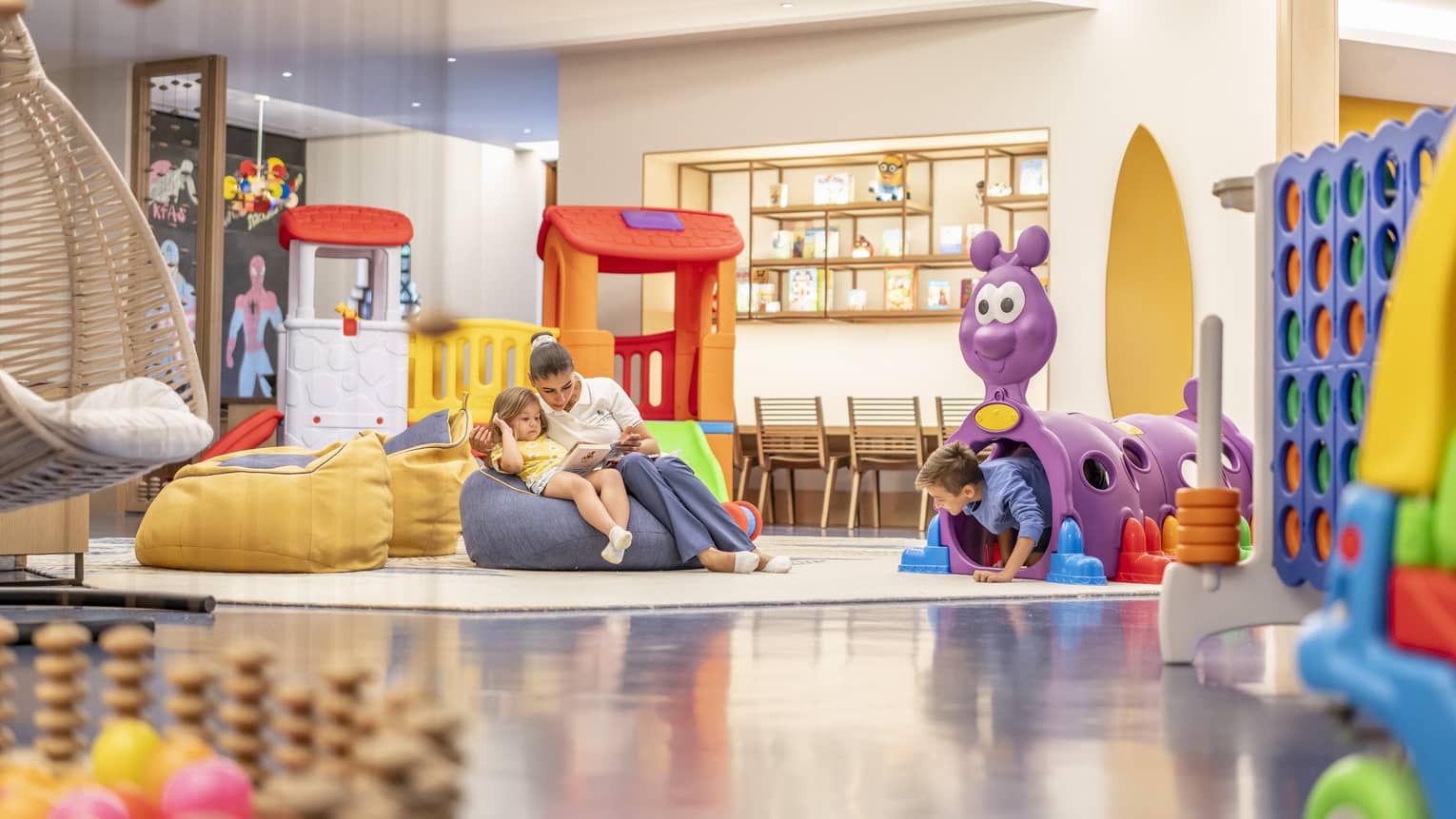 Kids playroom with colourful toys and bean-bag chairs
