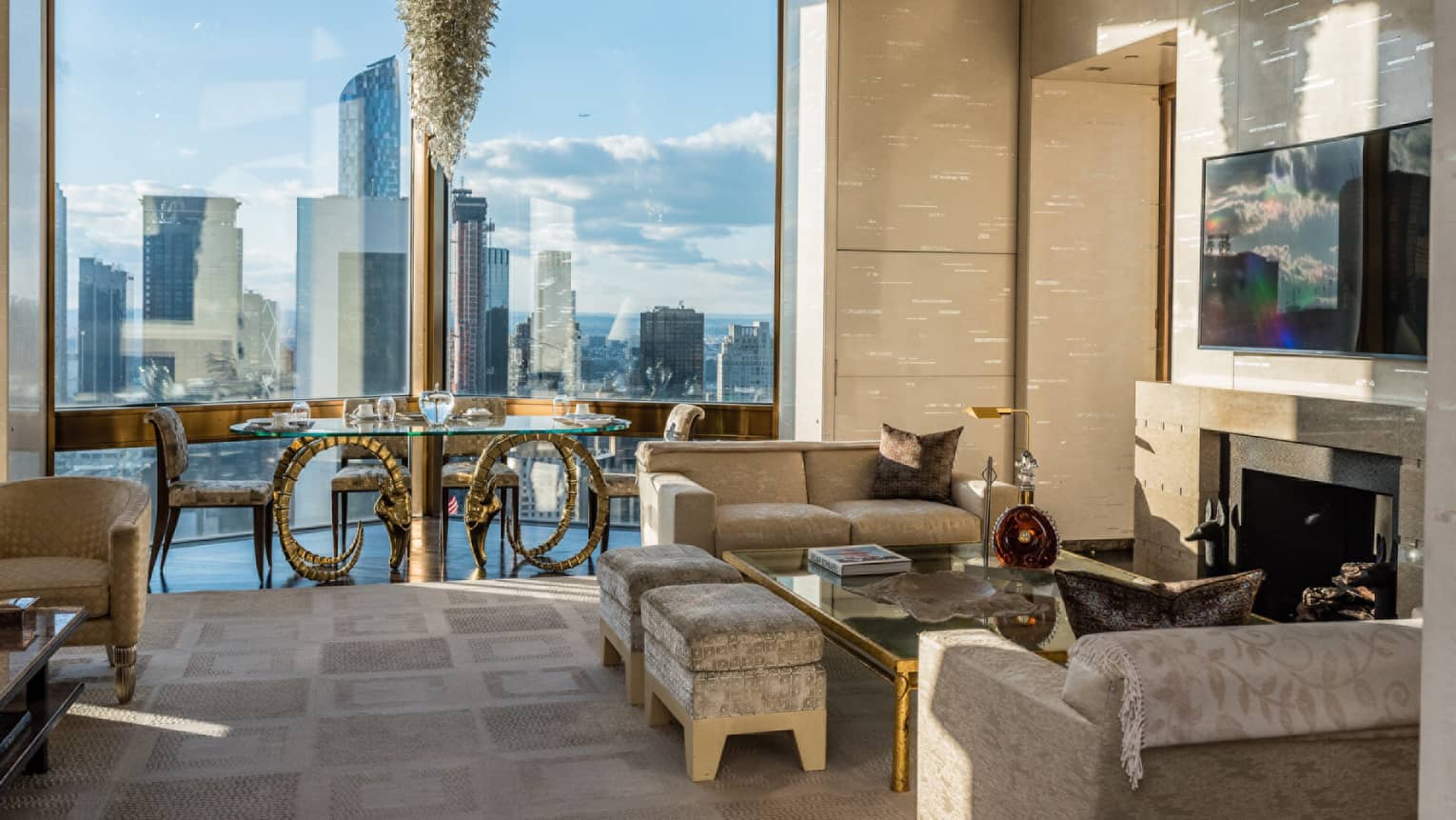 Bright Ty Warner Penthouse with modern gold dining table, chandelier by floor-to-ceiling window