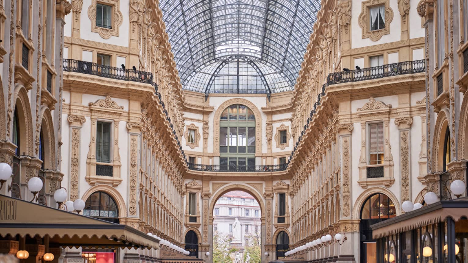 Historic Milan buildings and shops under glass vaulted ceiling