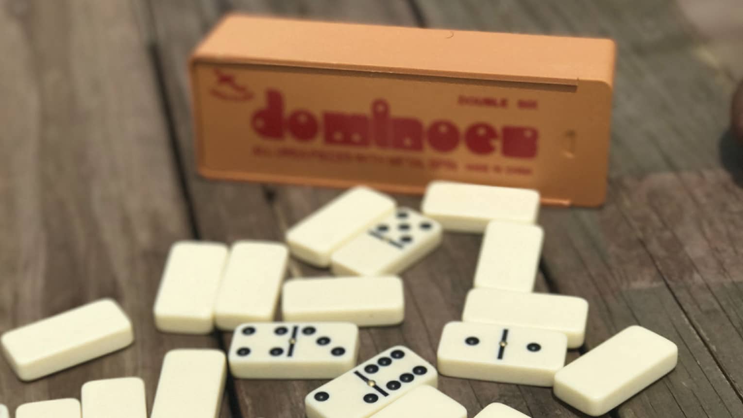 Dominoes on table, box in background