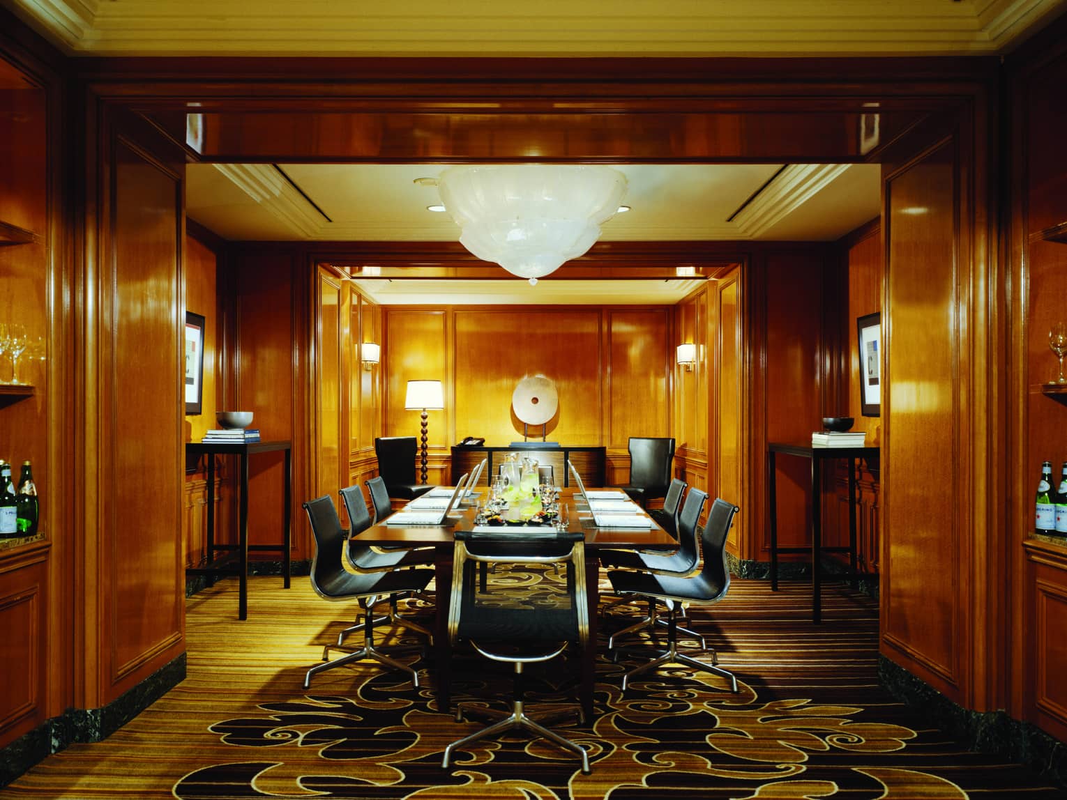 Long meeting table in Chateau Room with wood panel walls