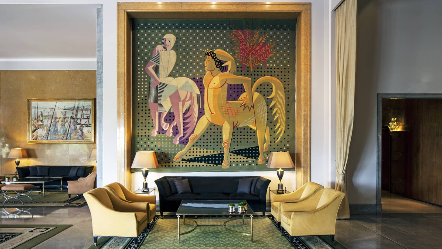 Almada Negreiros Lounge yellow armchairs below large handmade tapestry depicting centaurs