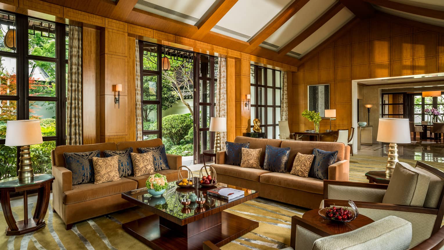 Presidential Villa with two orange velvet sofas, chairs around modern wood table