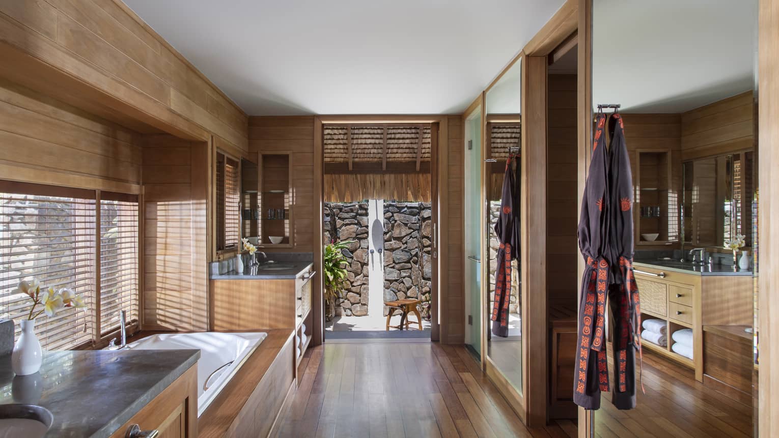 Teak-wood floors and walls in a villa's bathroom