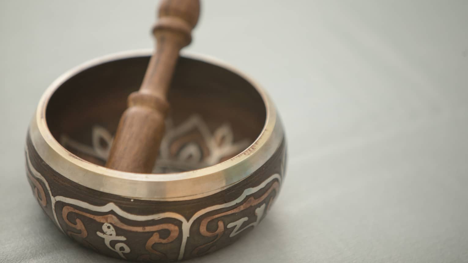 Small copper and wood bowl with decorative design, wood pestle