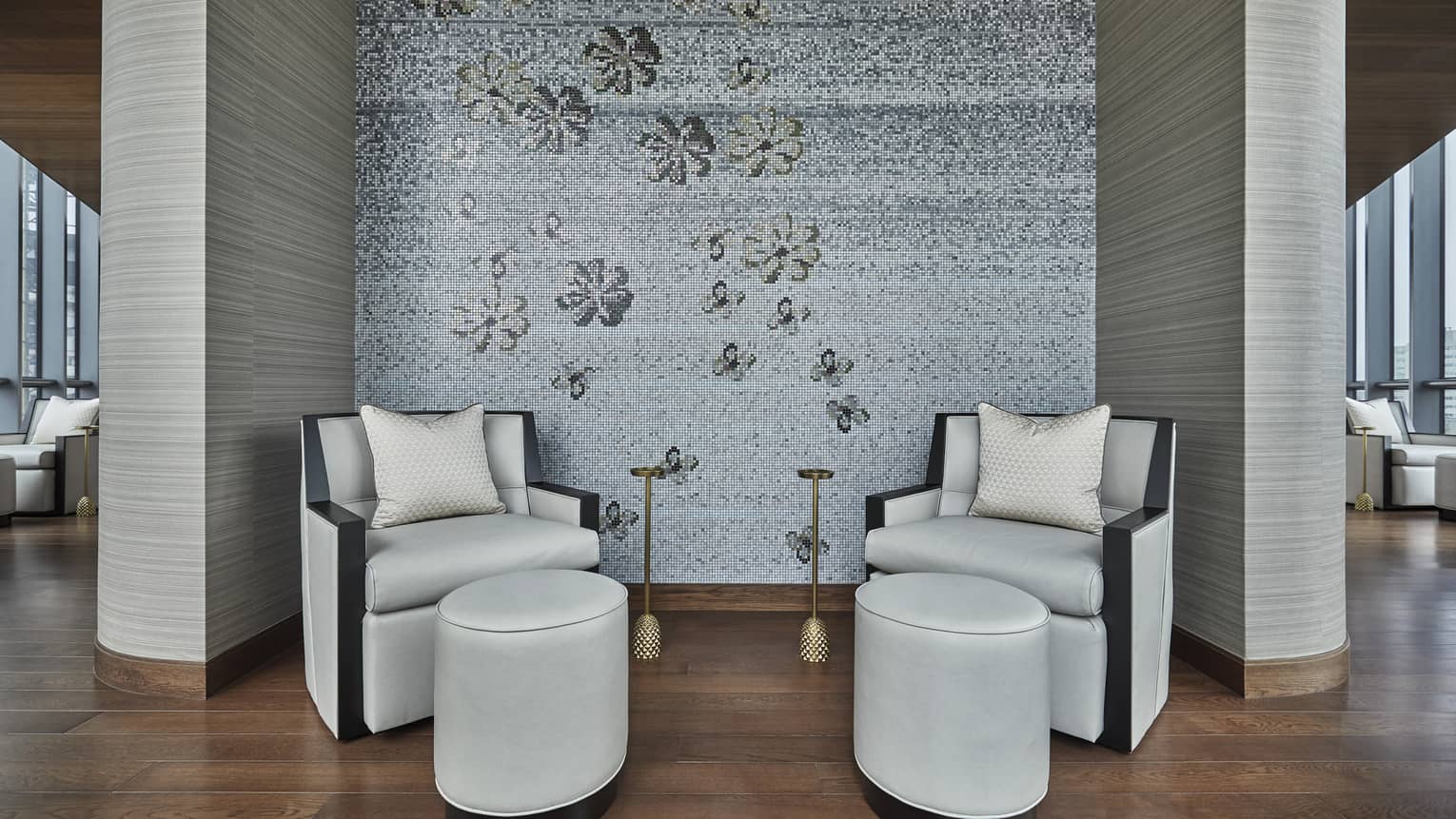 Two white leather chairs site in a corner of the Wellness Floor of Four Seasons Onedalton