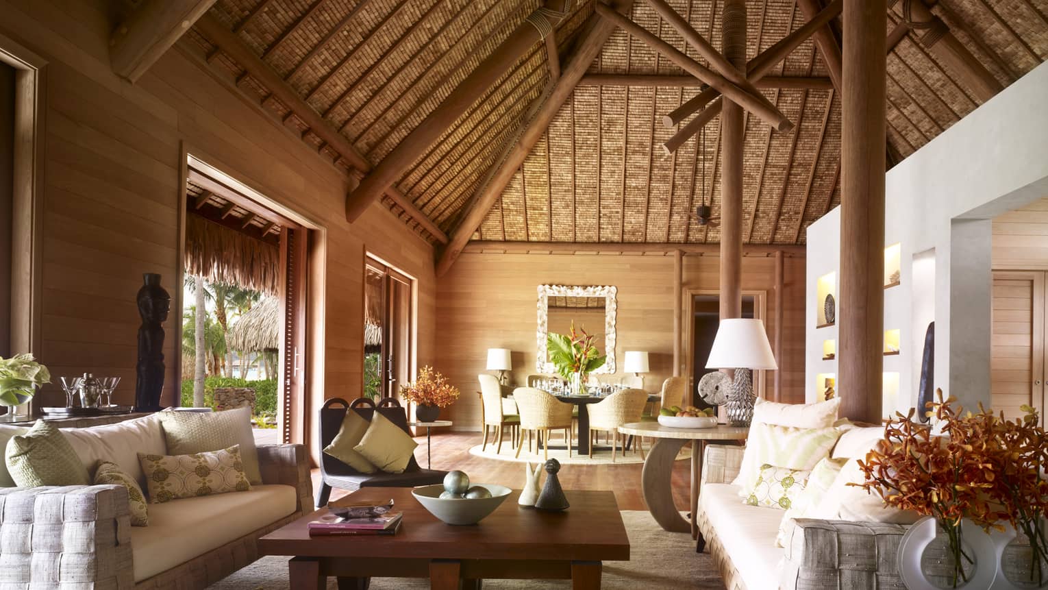 Large, bright bungalow with thatched cathedral ceiling, white sofas, Polynesian art 