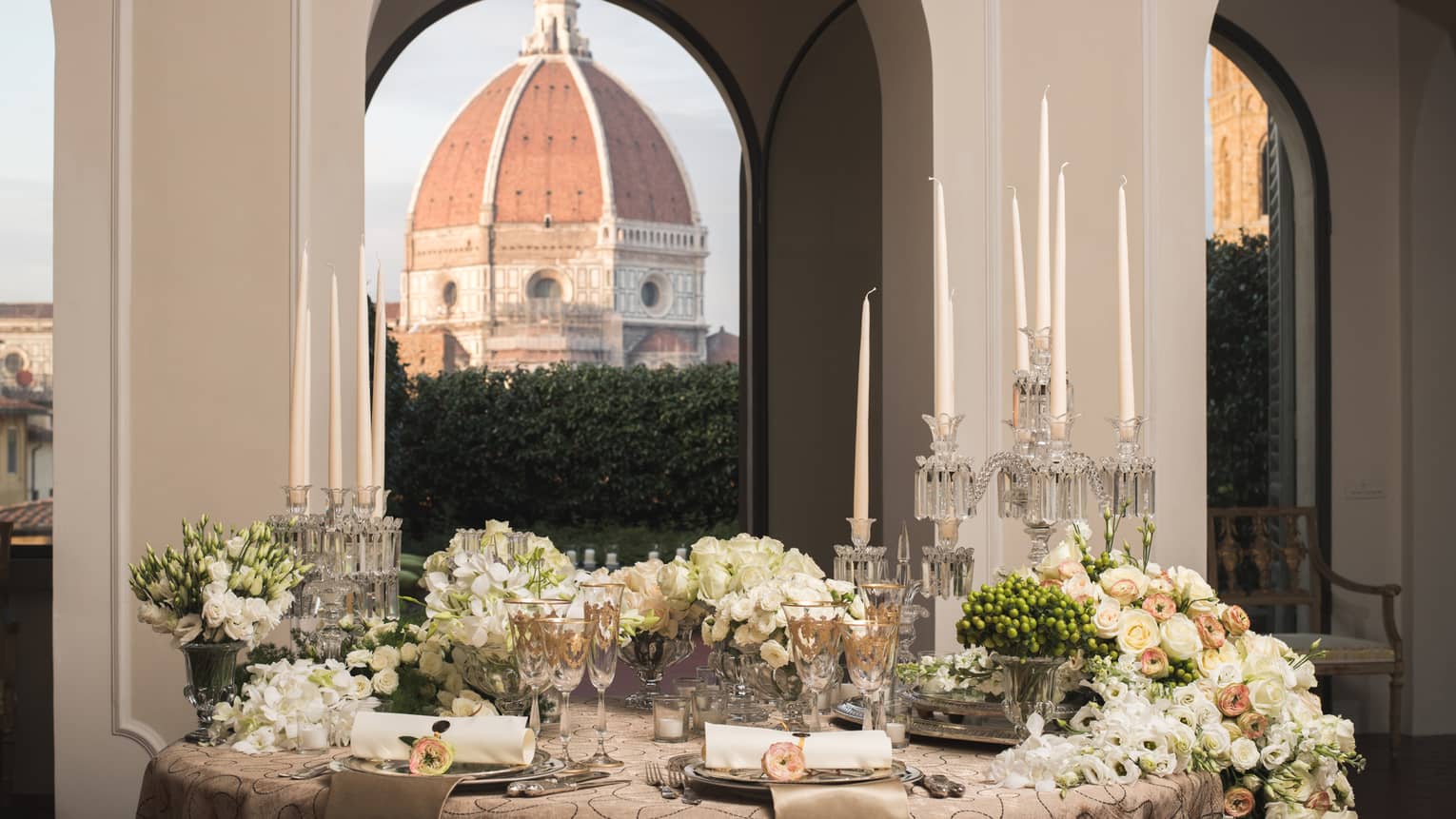 White roses, flowers on elegant banquet table under pillows, Duomo views