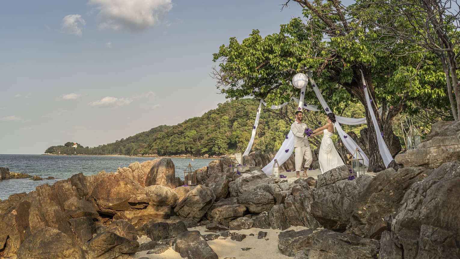 Couple exchanges wedding vows on craggy beach