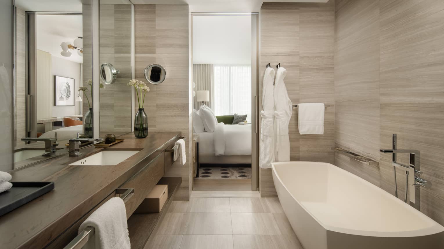 Hotel bathroom with standalone tub and long vanity at Four Seasons Hotel Toronto