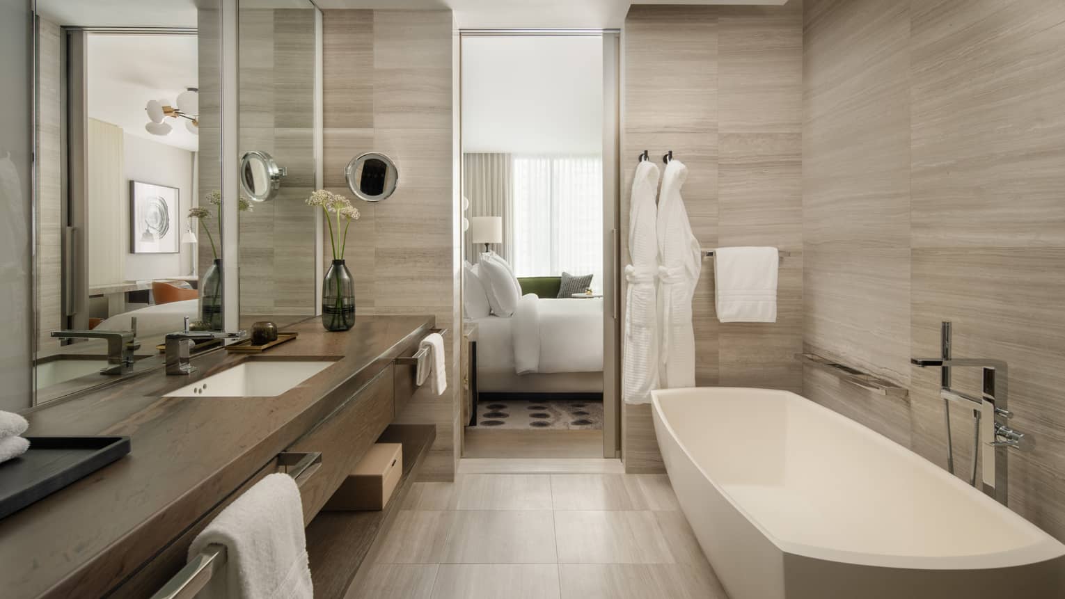 Hotel bathroom with standalone tub and long vanity at Four Seasons Hotel Toronto