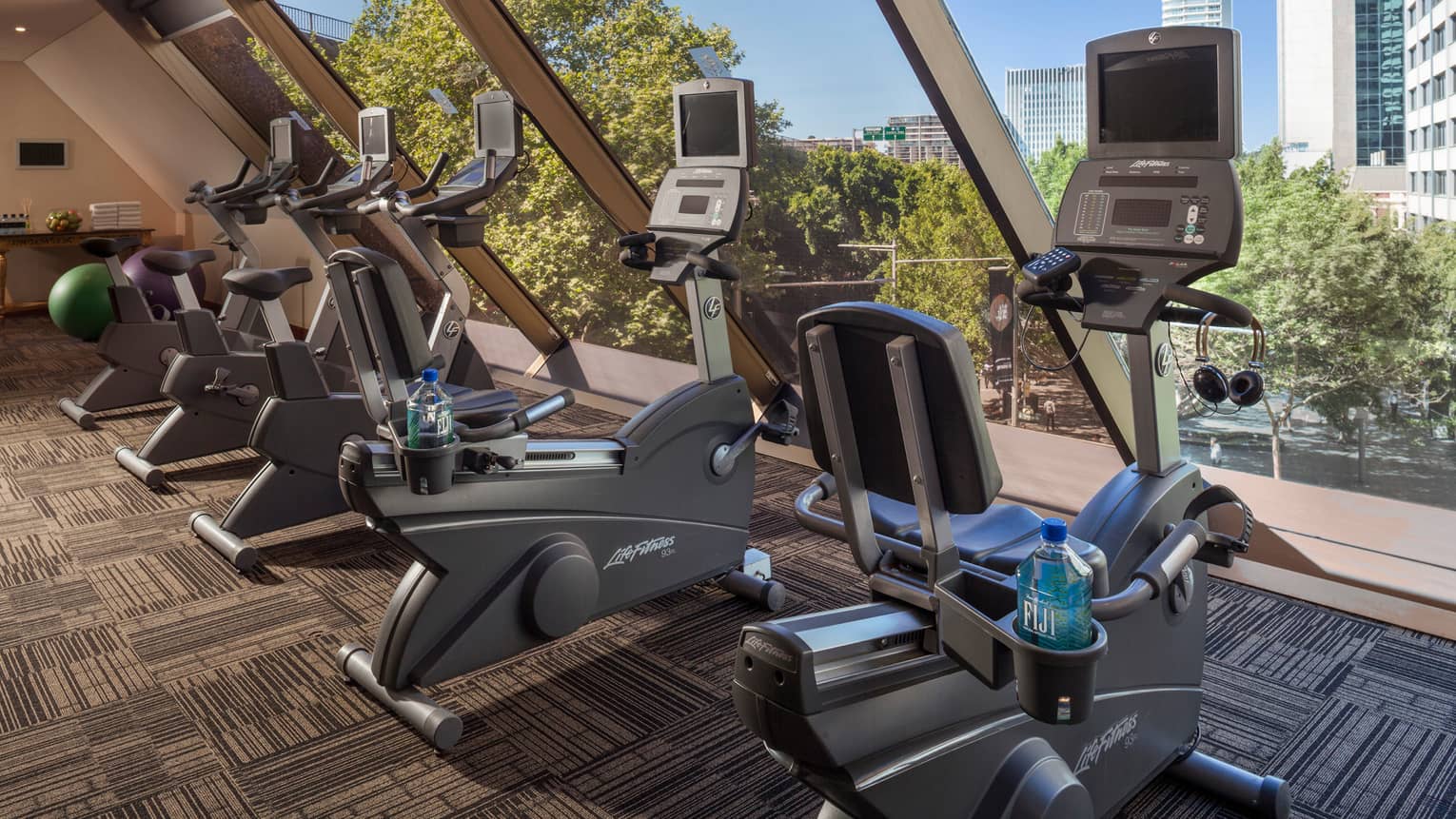 Cardio bikes, machines lined up by window in Fitness Centre