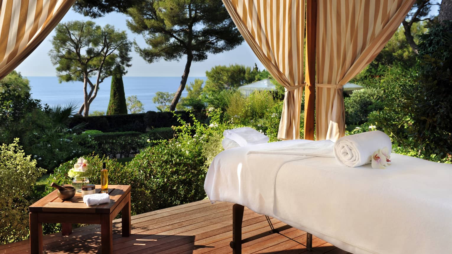 Massage bed on outdoor Spa pavilion overlooking gardens, sea