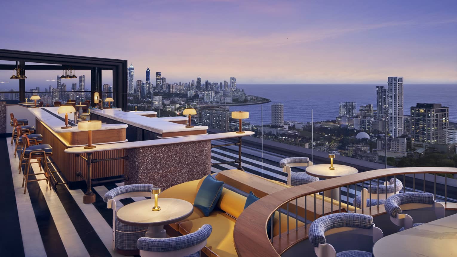 AER rooftop lounge at dusk with views of Mumbai skyline