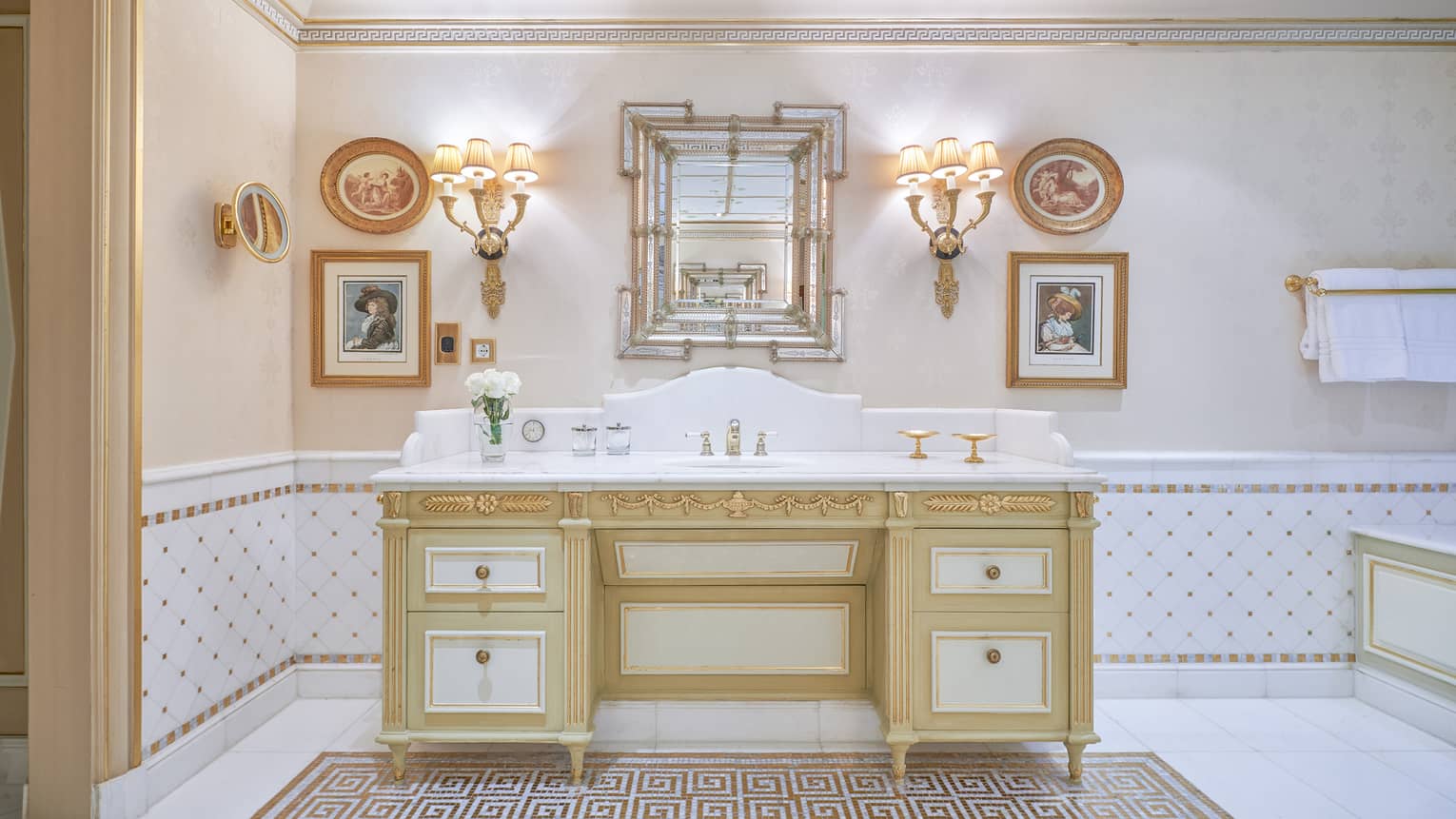 Royal Suite bathroom with single vanity, twin wall sconce lighting. gold accents