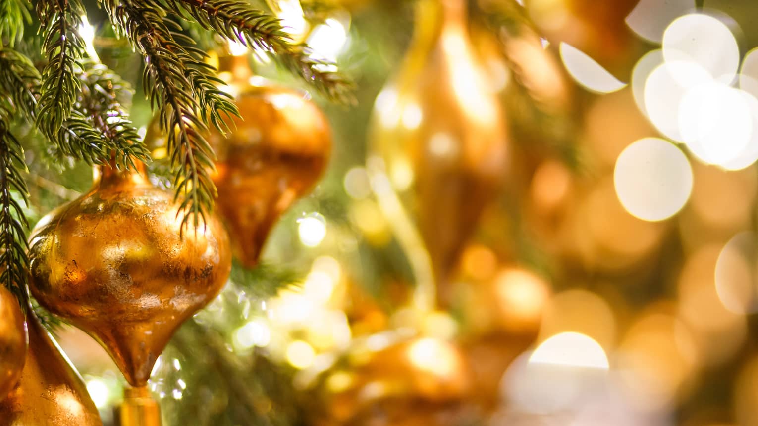 Close up of Christmas tree ornaments and lights.