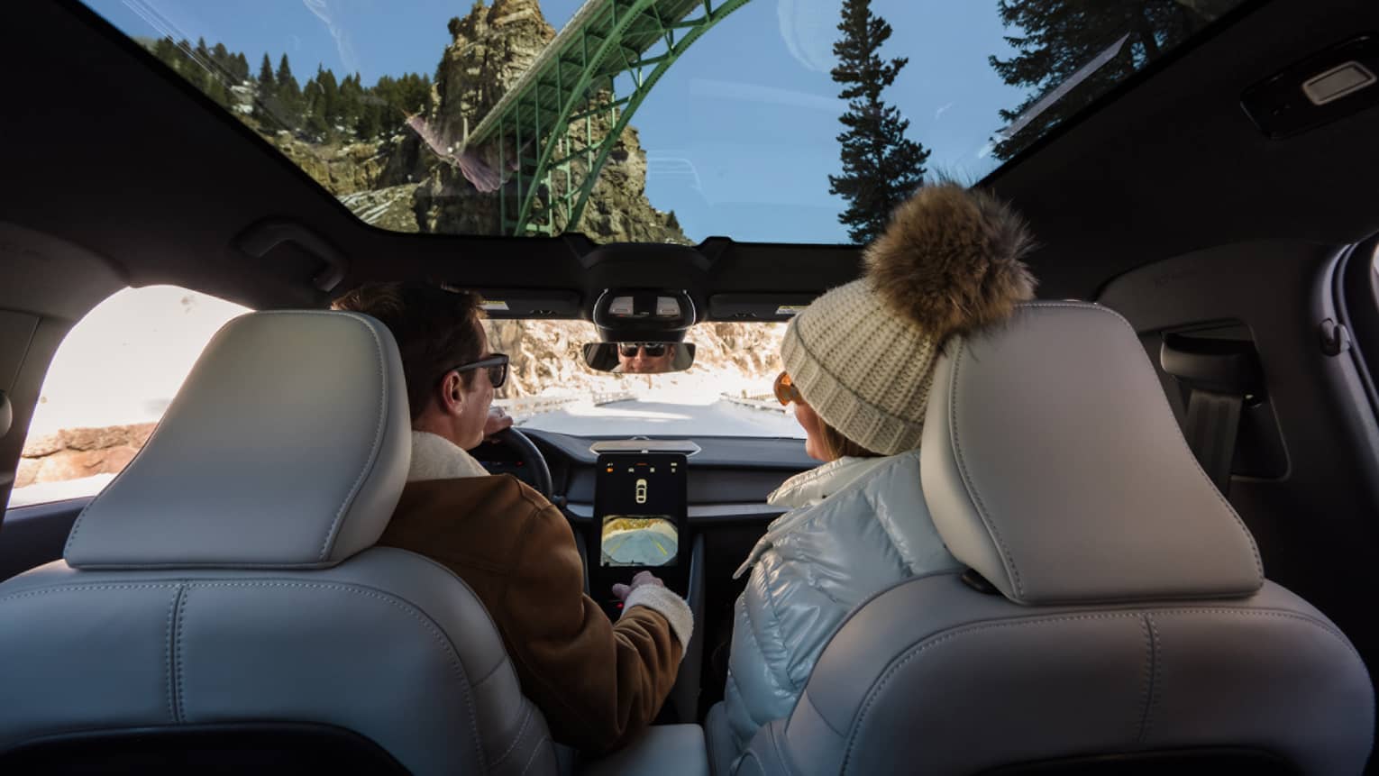 Two guests in a car using a navigation system.