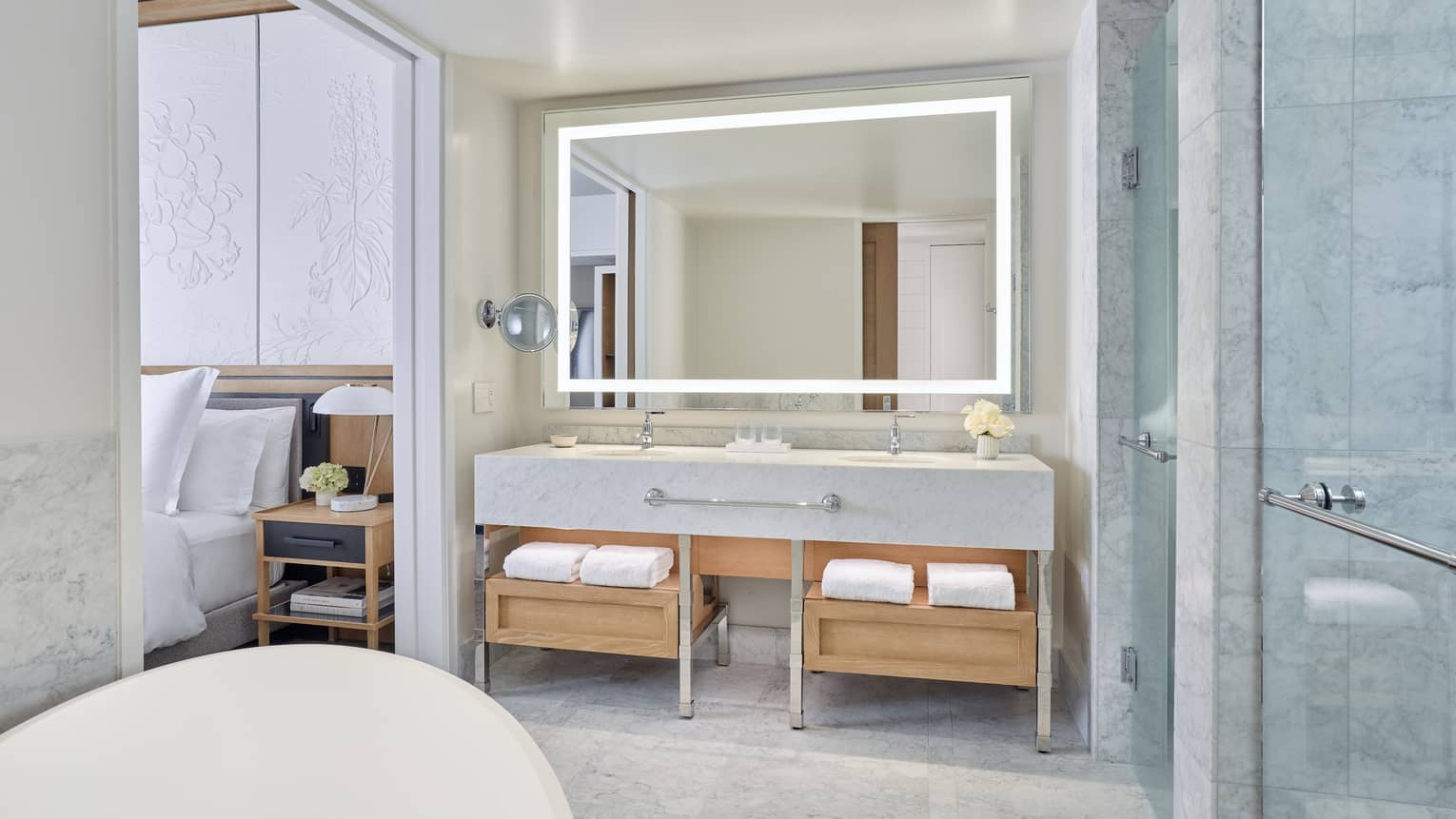 Deluxe City-View Room Bathroom with double vanity and full-width lighted mirror