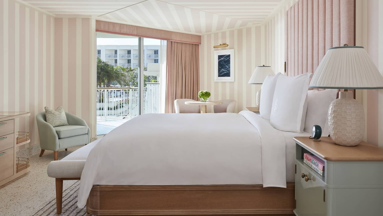 Ocean View Cabana Terrace Room hotel bed, lamp against pink and white walls