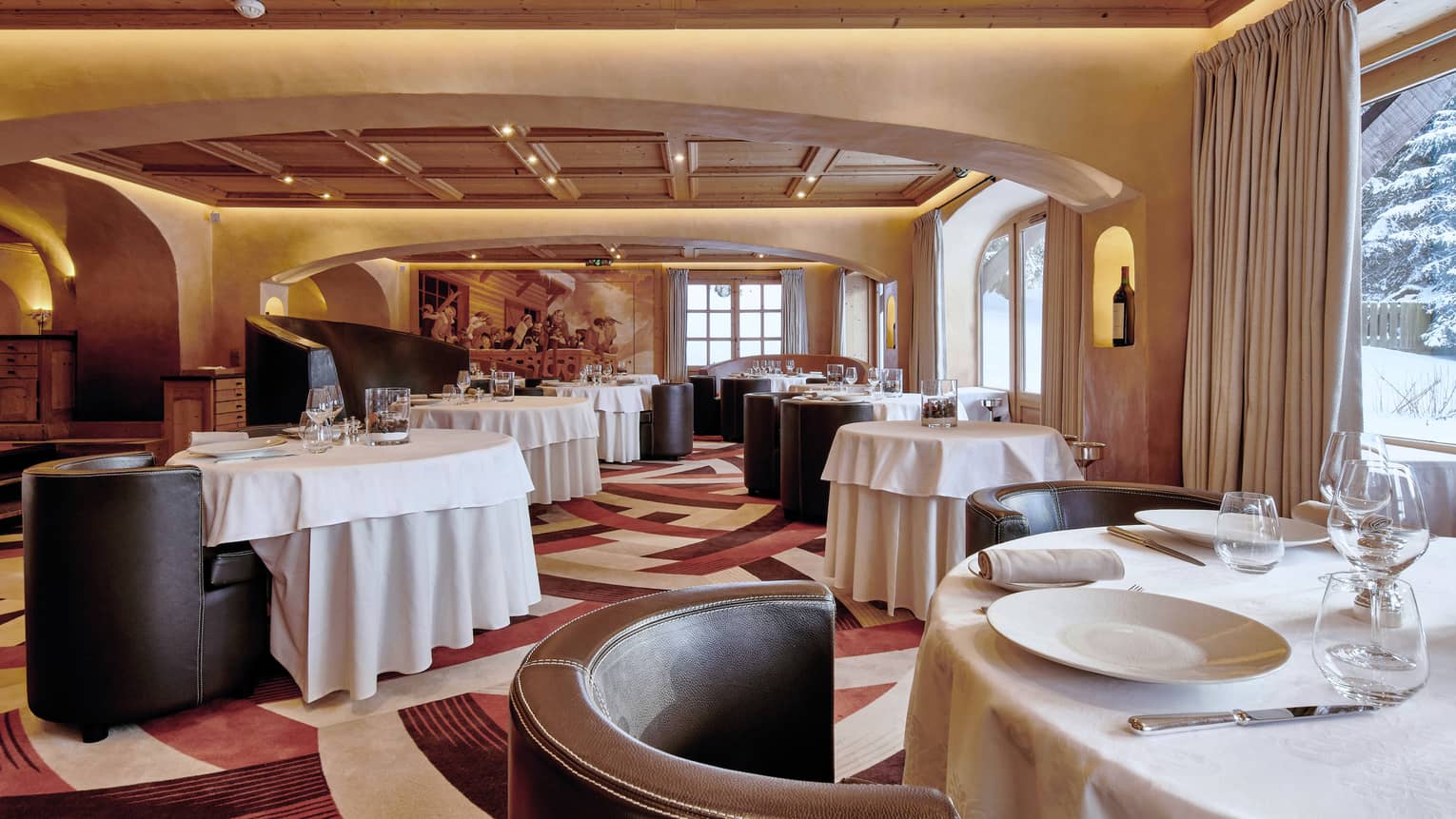 Prima Restaurant, curved leather lounge chairs, dining tables with white linens 